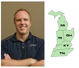 Man smiling with folded arms beside a regional map of Midwest states.