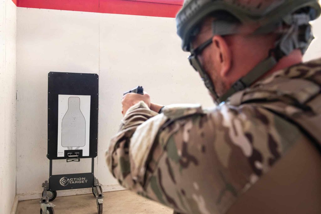 Man in military shooting pistol at autotargets