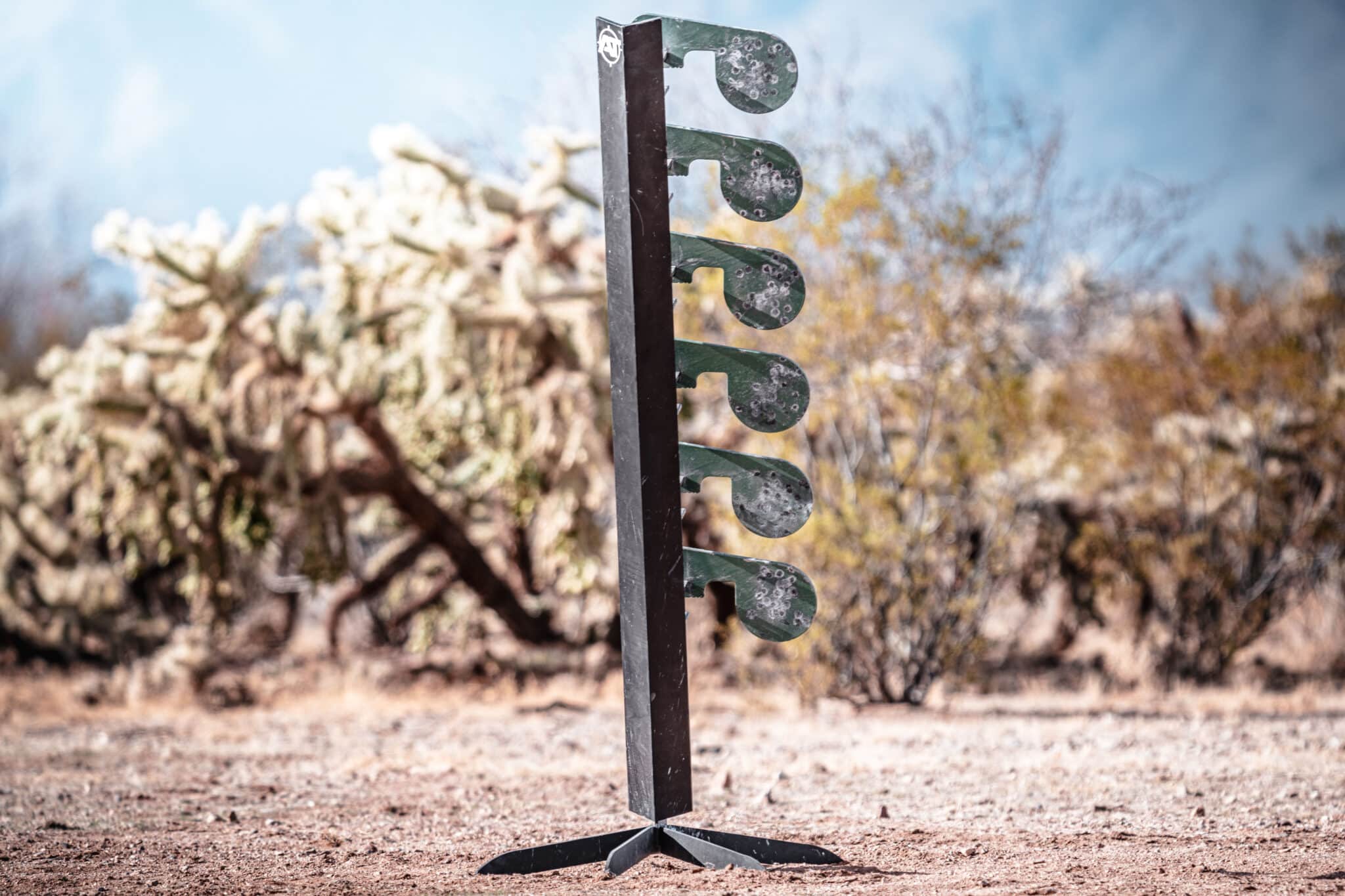 Steel dueling tree target with reactive paddles set up at an outdoor shooting range.
