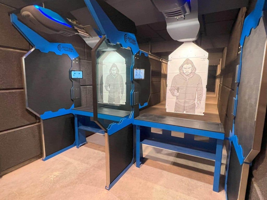 Target on shooting range table, featuring black-and-blue dividers in an enclosed room.