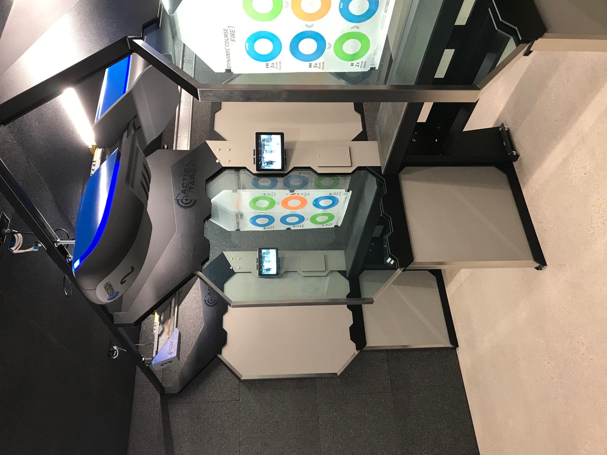 Targets in shooting range stall, featuring large screens and labeled 