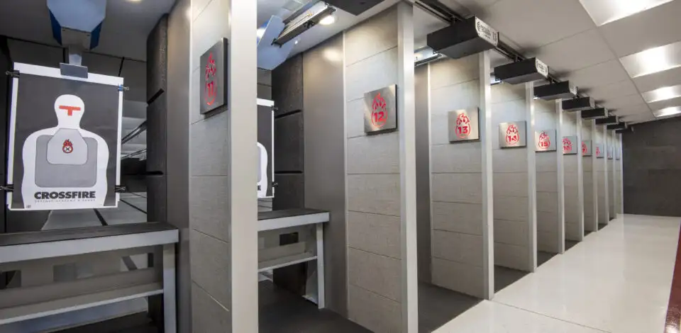 Indoor shooting range with individual lanes, target retrieval system, and paper silhouette targets.