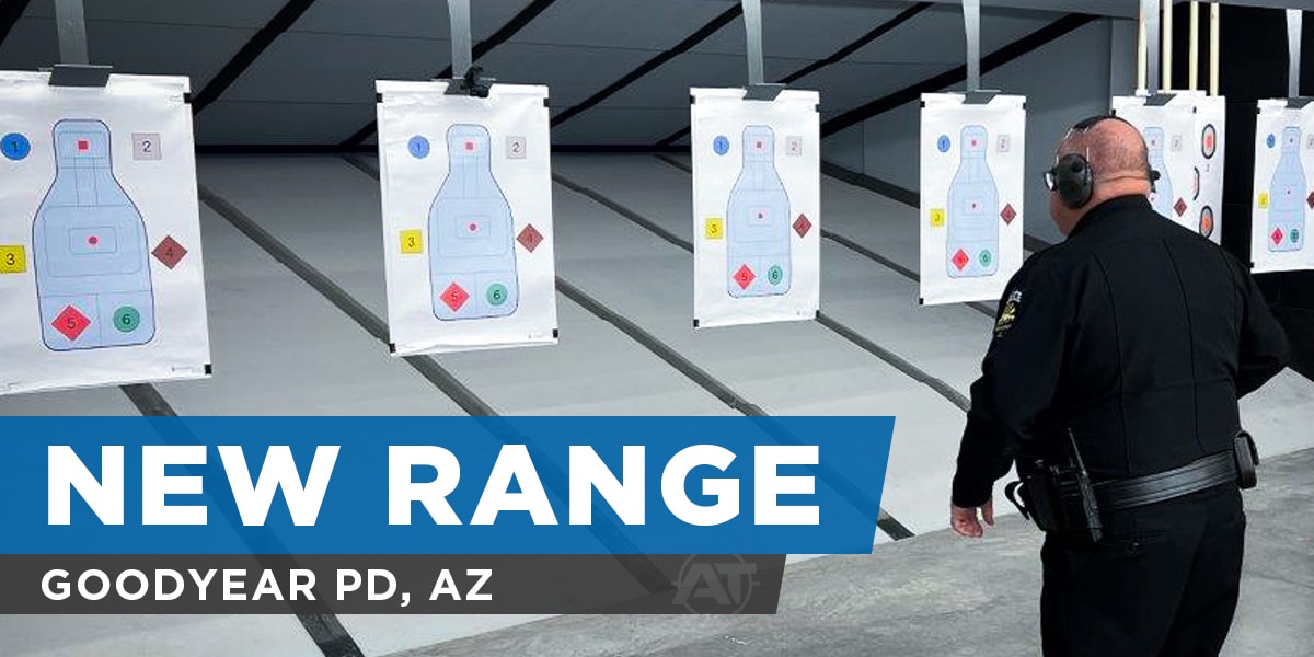 Police officer observing paper silhouette targets at new indoor shooting range in Goodyear, AZ