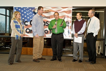 Five people stand, one holding an award, in front of a banner with text: "PSI CROSSFIRE Orlando FL."