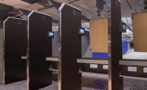 Firing range booths with target holders suspended in an indoor shooting range.