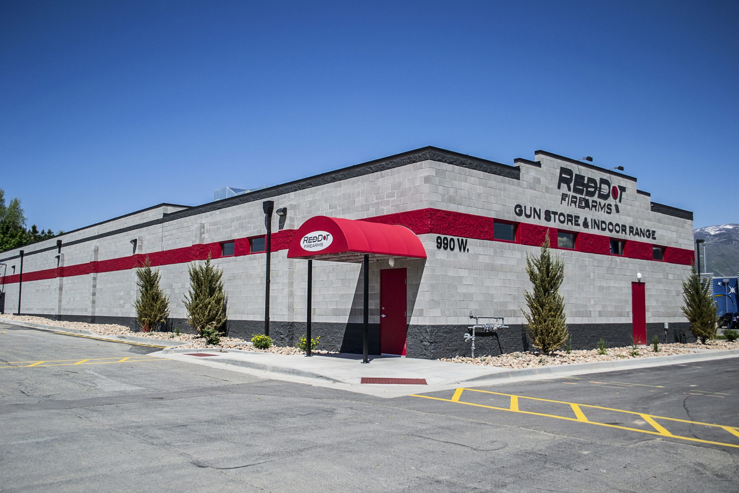 Building with gray walls, red awning; labeled "REDDOT FIREARMS, GUN STORE & INDOOR RANGE, 990 W."