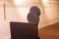 Steel target mounted on a floor base with reset mechanism.