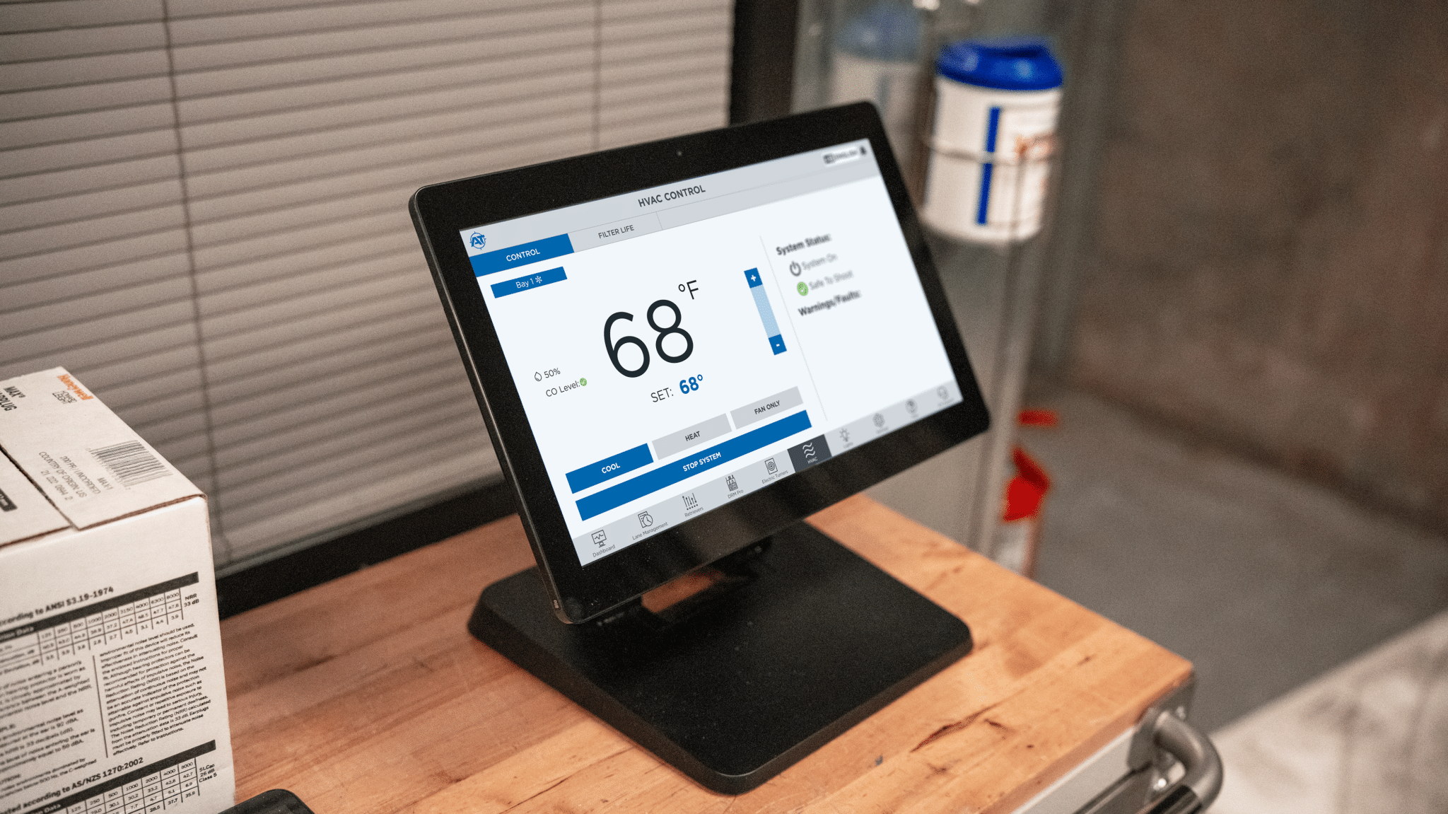 Touchscreen control panel displaying HVAC system settings at 68°F with system status indicators and filter monitoring options.