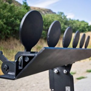 Row of black steel round shooting targets mounted on a metal frame at an outdoor range.