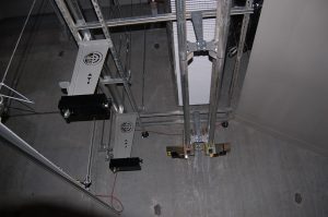 Overhead target retrieval system installed in an indoor shooting range.