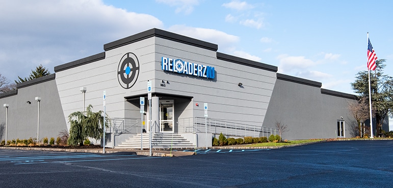 Reloaderz indoor shooting range and gun store exterior with modern building design.