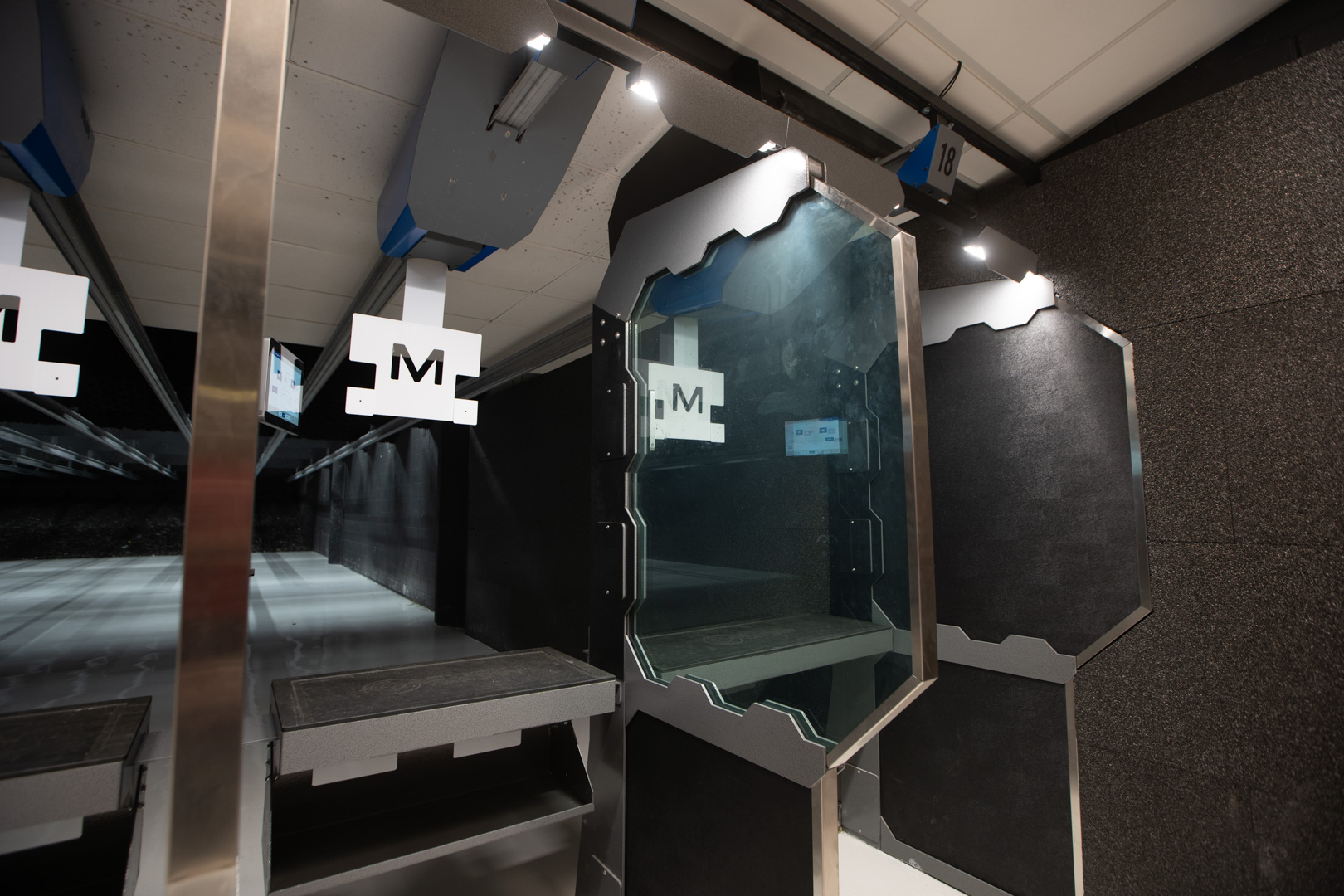 A brightly illuminated stall in a commercial indoor range