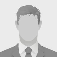 A faceless black and white character icon of the upper body of a man in a suit with dark short hair.