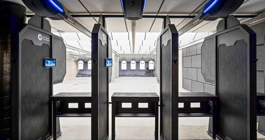 Downrange angle of a commercial indoor shooting range from behind the firing line